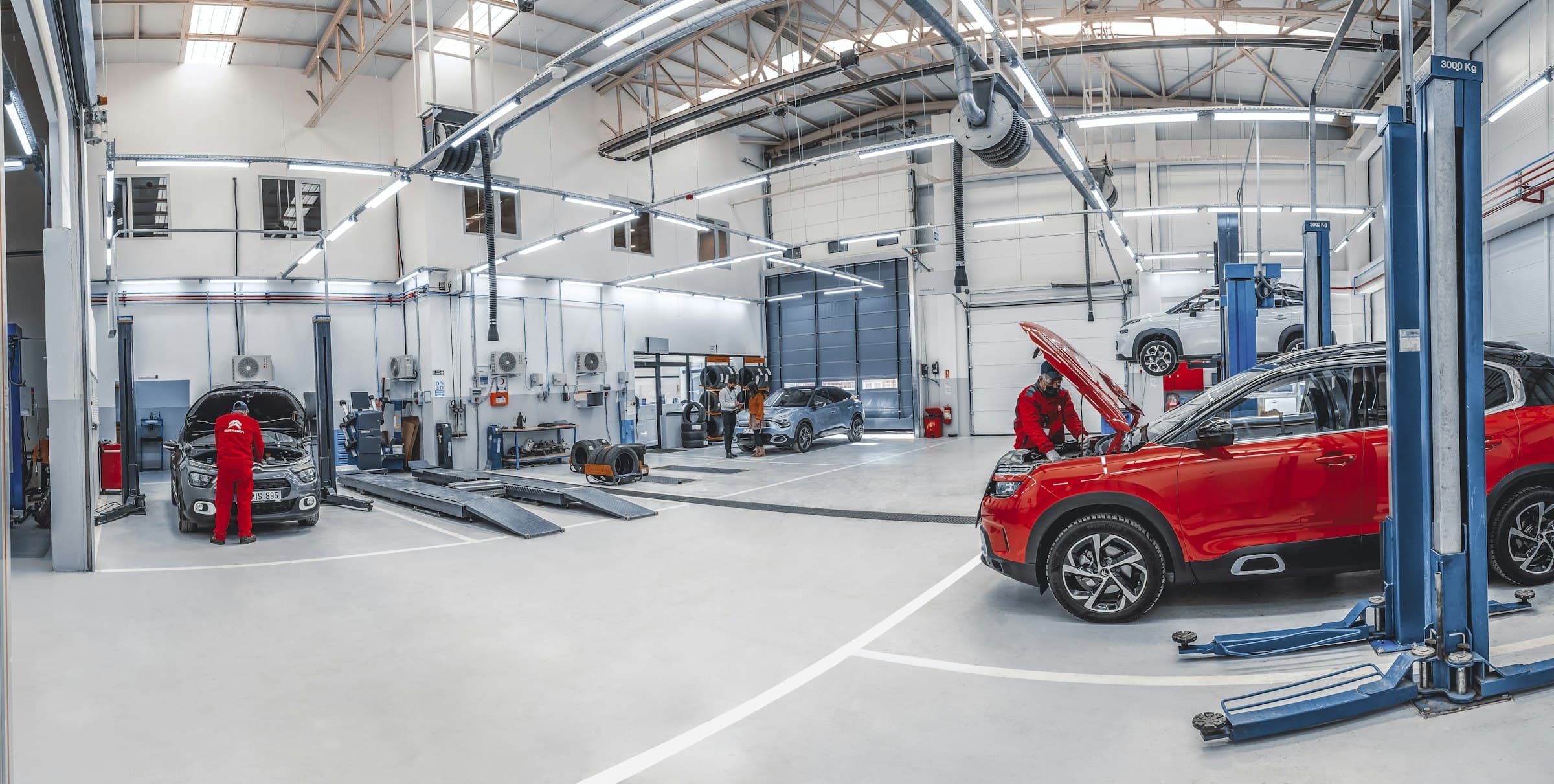 A mechanic working on a car in a clean workshop